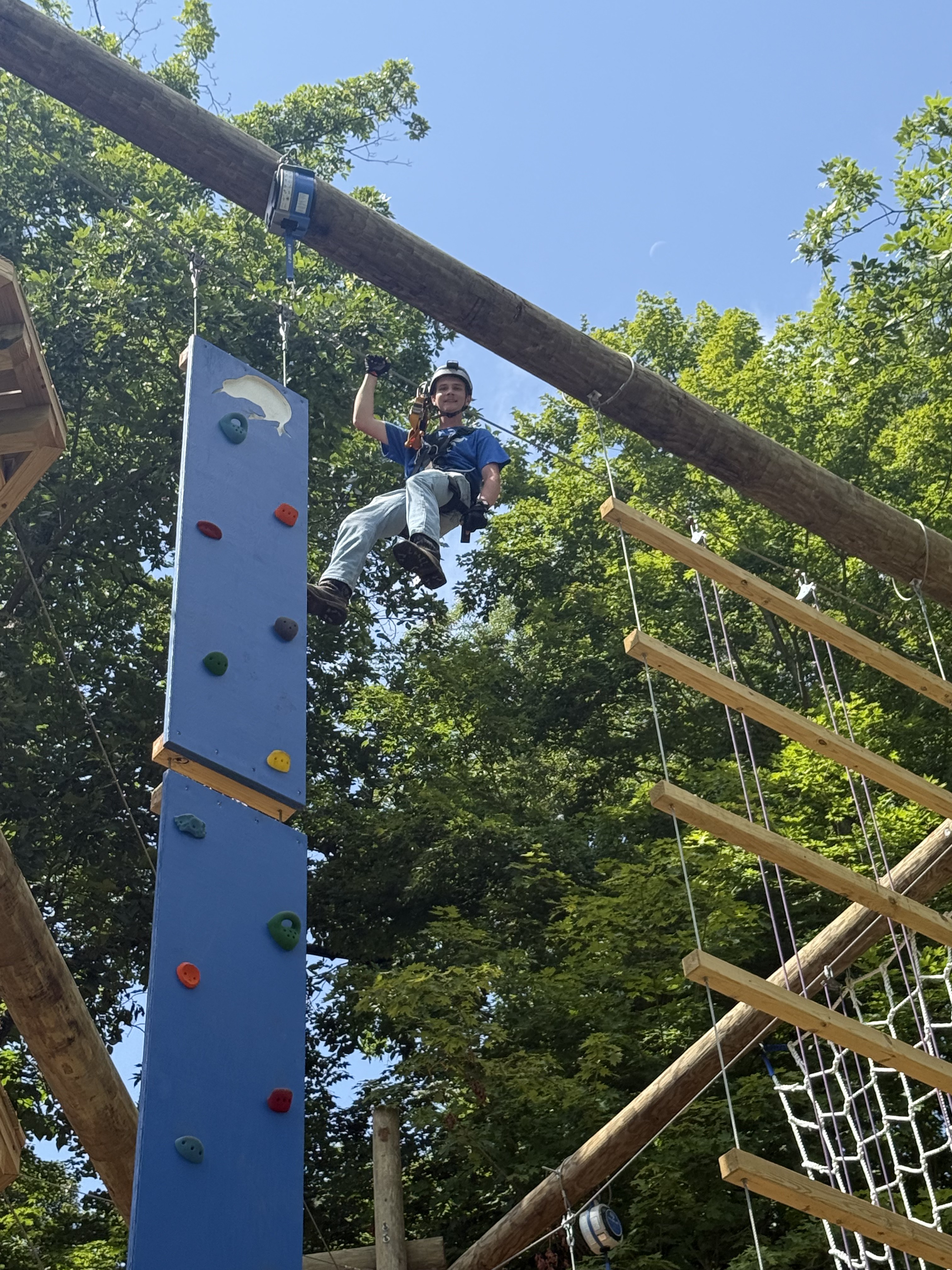 Climber on an elevated ropes course at Kiwi Country Day Camp